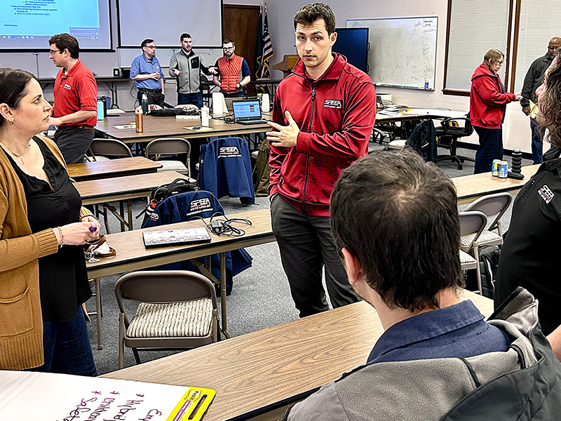 Negotiation team members meet with staff to discuss employee relations